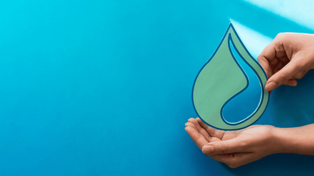 Hands holding a water drop cut-out symbolising water conservation and management in South Africa.