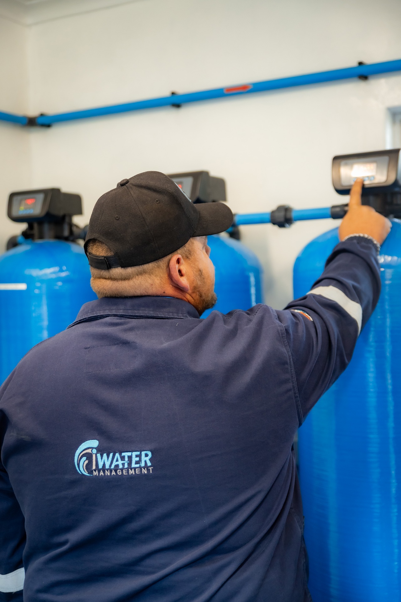 Technician at filtration tanks back view