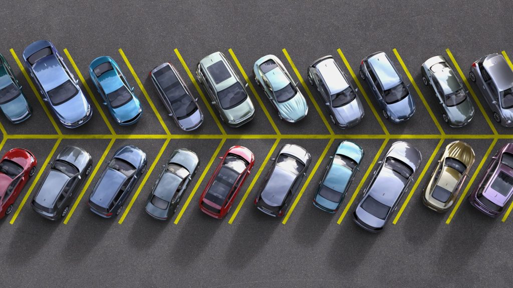 Overhead view of a fully occupied parking lot in a commercial space, symbolizing high business activity supported by reliable operations.
