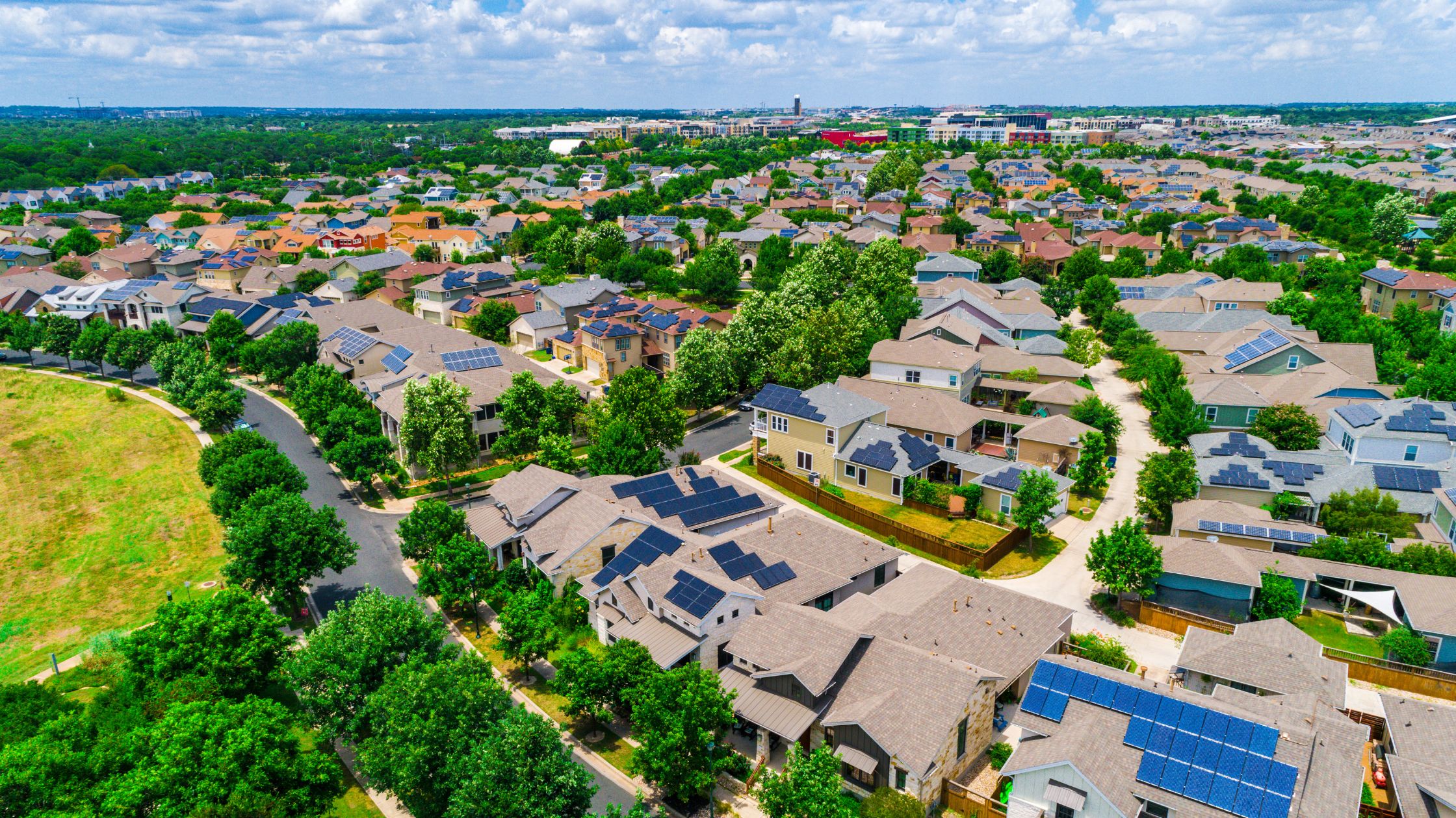 Modern residential home with rooftop solar panels, representing sustainable energy solutions used in lifestyle estates for off-grid water systems.